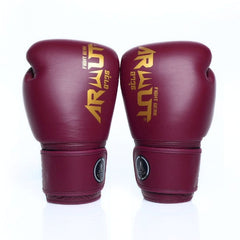 Pair of maroon boxing gloves with gold logo on a white background