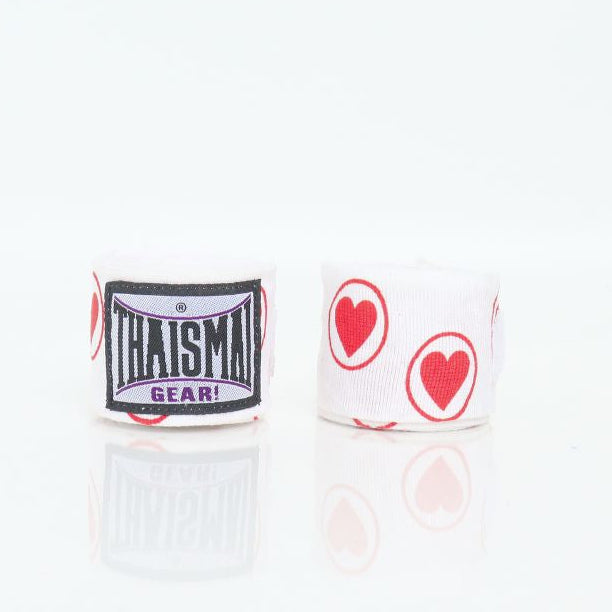 Two pairs of white hand wraps with red heart designs on a white background, featuring the brand 'Thaism'.