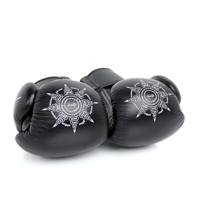 Black boxing gloves with a white emblem on a white background