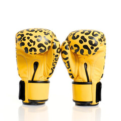 Yellow boxing gloves with black leopard print pattern on a white background
