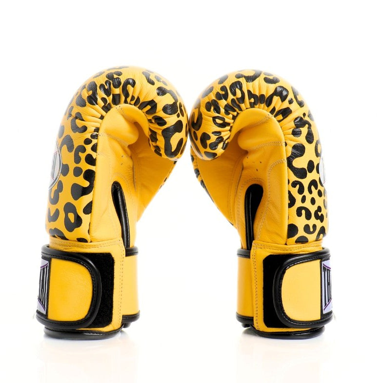 Yellow boxing gloves with leopard print pattern on a white background