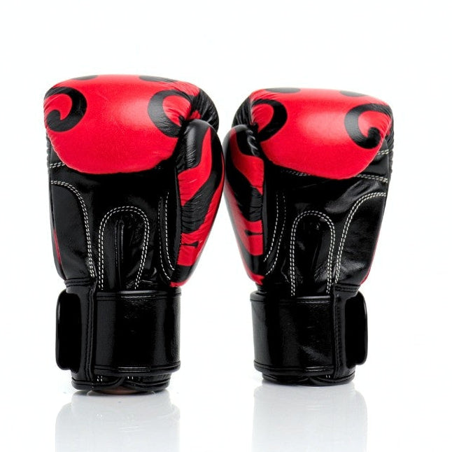 Pair of red and black boxing gloves on a white background