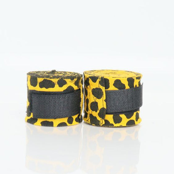 Two rolls of black and yellow boxing wraps on a white background