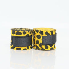 Two rolls of black and yellow boxing wraps on a white background