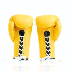 Pair of yellow boxing gloves with black and white accents on a white background