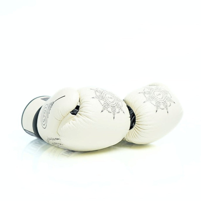Pair of white boxing gloves with black accents on a white background