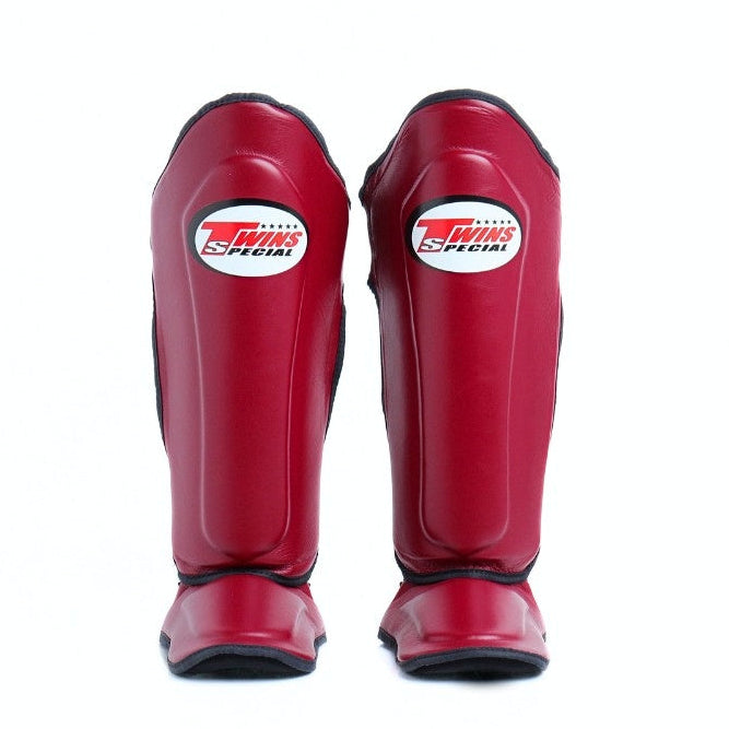 Red shin guards with a brand logo on a white background