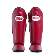 Red shin guards with a brand logo on a white background