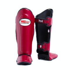 Red and black shin guards with a brand logo on a white background