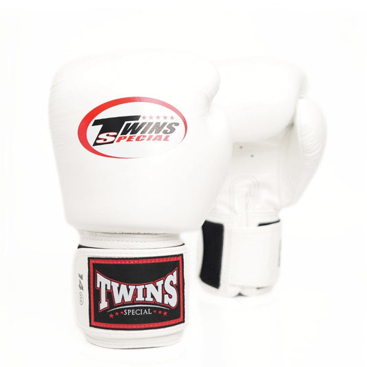 A pair of white Twins Special boxing gloves on a clean white background, showing the front glove with its red and black logo and the rear glove showing its strap closure.