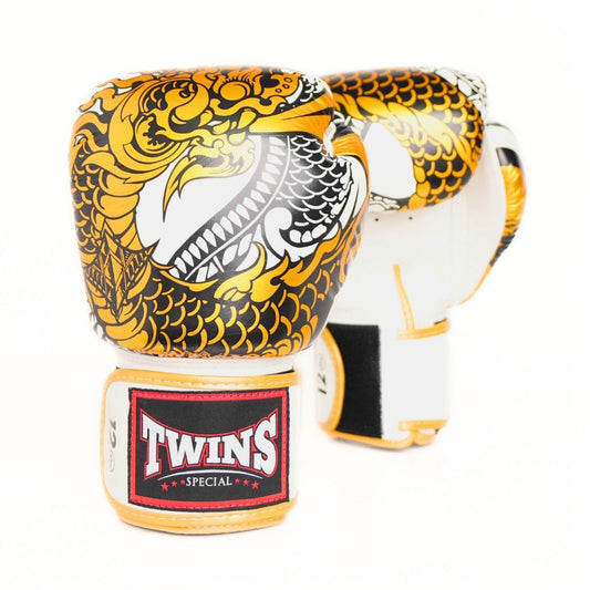 A pair of Twins Special boxing gloves featuring a striking black, gold, and white dragon graphic on the front, with the brand's 'TWINS SPECIAL' logo visible on the wrist strap.